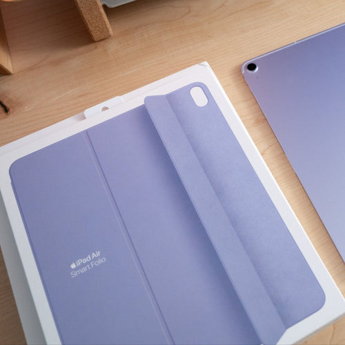 Purple Apple device with packaging on a wooden surface